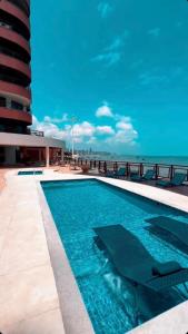 a swimming pool with a view of the ocean at Iate Plaza Flat 613 in Fortaleza