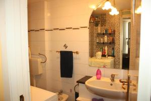 a bathroom with a sink and a toilet and a mirror at Casa Vacanza Da Andrea in Naples