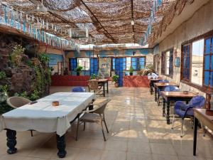 a restaurant with tables and chairs in a room at New Palace Hotel in Cairo