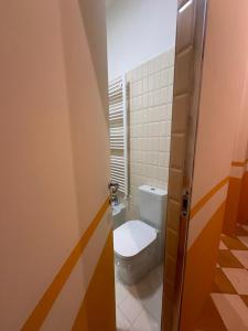 a bathroom with a toilet and a door open at Le Case di LuVi in Nola +92 photos