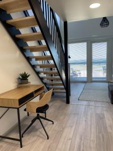 a staircase in a house with a desk and a chair at Spacious loft apartment with Lake Näsijärvi views in Tampere