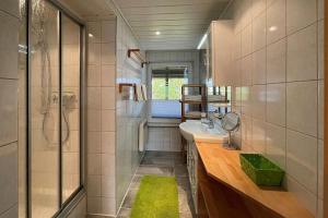 a small bathroom with a sink and a shower at Ferienhaus-Hellmich in Scheibe-Alsbach