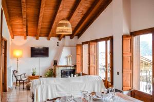 a dining room with a table and a fireplace at La Cabanya de la Rovira in Joanetes