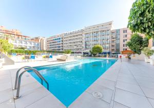 a swimming pool in the middle of a building at Port Vista Oro in Benidorm