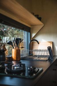 a kitchen counter with a dish rack on a stove at White House Hideaway in Brockhampton