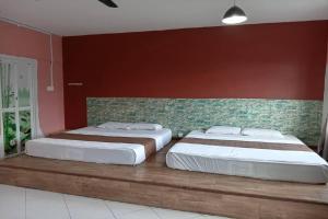 two beds sitting next to each other in a bedroom at Aeon Tebrau Apartment Johor Bahru - By Room - in Johor Bahru