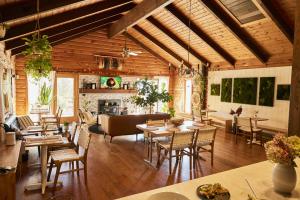 a large living room with wooden ceilings and tables and chairs at Sowilo All-inclusive Resort in Greenwich