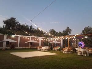 a group of tables and chairs under a marquee with lights at HOTEL HACIENDA SUBTANJALLA CASABLANCA in El Cambio