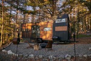 a tiny house sitting in the middle of a forest at Sowilo All-inclusive Resort in Greenwich