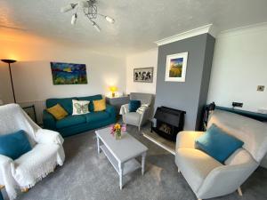 a living room with two couches and a table at Fields View in Newbridge