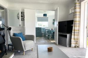 a living room with a chair and a table at Fields View in Newbridge
