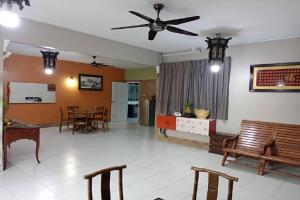 a living room with chairs and a ceiling fan at Aeon Tebrau Apartment Johor Bahru - By Room - in Johor Bahru