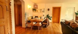 a living room with a table and a couch at Chalet Am Sonnberg in Kirchberg in Tirol