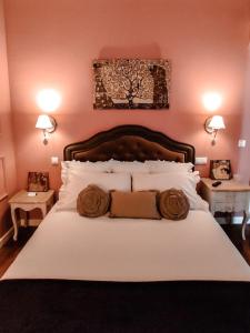 a bedroom with a large bed with two night stands at Insula Barataria in Belmonte