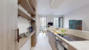 a kitchen with white walls and wooden countertops at Santa Cruz in Madrid