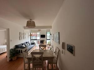 a dining room and living room with a table and chairs at apart las piedras 2 in San Miguel de Tucumán