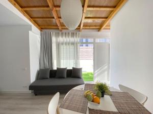 a living room with a couch and a table at MarBarcelona Apartments Mas At b in Hospitalet de Llobregat