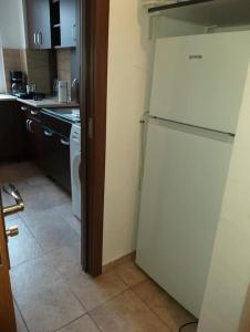 a kitchen with a white refrigerator in a room at Ultracentral free private parking in Ploieşti