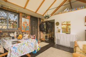 a living room with a table and a room with at Finest Retreats - The Ratcatchers Cottage 