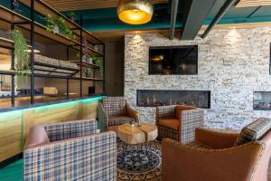 a lobby with couches and a fireplace at Luxe appartement in haven Marina Kamperland - 2 badkamers in Kamperland
