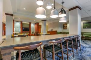 a lobby with a large bar with chairs and tables at Fairfield Inn and Suites Holiday Tarpon Springs in Holiday +14 photos