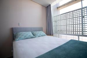 Кровать или кровати в номере Lindo Apartamento - Copan SP