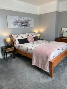 a bedroom with a bed and a table with a night stand at Cosy Stay in the Heart of Dover in Kent