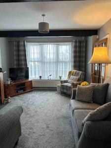 ein Wohnzimmer mit einem Sofa und einem TV in der Unterkunft Cosy Stay in the Heart of Dover in Kent