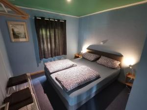 a bedroom with a bed with two pillows on it at adBs Ferienhaus in Winterberg