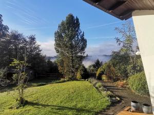 a view of the garden from the porch of a house at adBs Ferienhaus in Winterberg +7 photos