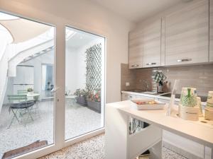 a kitchen with a view of a dining room at Zuara9Room Rimini in Rimini