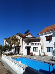 a house with a swimming pool in front of it at Vila Jovana A in Rogljevo