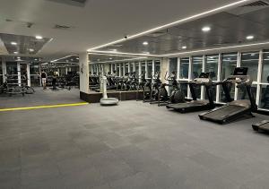 a gym with rows of treadmills and elliptical machines at Brand new apartment in Dubai Marina 47th floor in Dubai