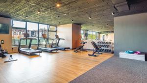a gym with treadmills and exercise equipment in a building at Polanki Aqua Nature View in Kołobrzeg