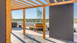a patio with a wooden pergola and a table at Polanki Aqua Nature View in Kołobrzeg