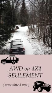 a car is parked on a snow covered road at Chalet Le Pélican in Lac-Superieur