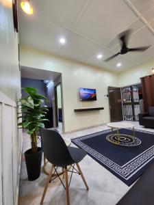 a living room with a table and a couch at Sun Star Home by Ipoh Maju Stay in Ipoh
