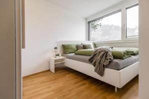 a bed in a room with a window at Smart Living Dornbirn in Dornbirn