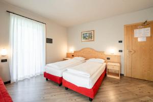 Postel nebo postele na pokoji v ubytování Garnì Letizia