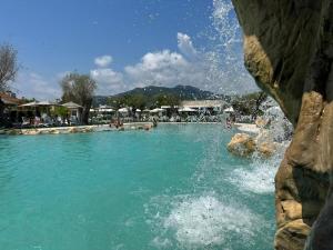 a swimming pool with people in the water at Resort Petrasia in Villammare