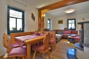 a living room with a table and chairs and a couch at Ferienhaus Chalet zur Werraquelle in Masserberg