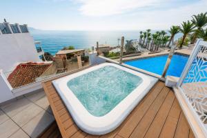 a hot tub on a balcony with a view of the ocean at HC Calahonda Beach Nerja in Nerja