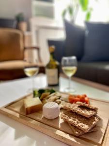 a wooden cutting board with sandwiches and a glass of wine at The Big Island in Paris