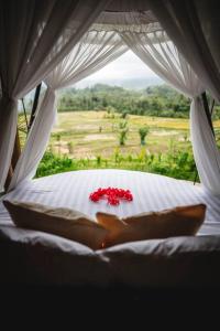 uma vista de uma cama com uma flor sobre ela em The Nude House em Selat