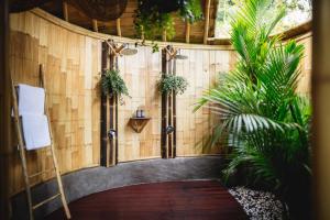 a room with a wooden wall with plants on it at Jiva Bali - Inaya in Selat