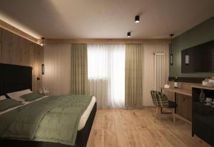 a bedroom with a bed and a desk and a television at Hotel Belfiore in Monclassico