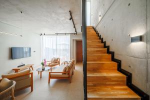 a staircase in a living room with a table and chairs at Greenvale Park Villas in Paphos