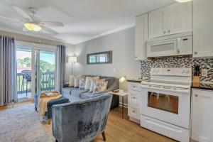 a living room with a couch and a kitchen at Hamlet's Passion Beach in Tybee Island