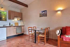 a kitchen and dining room with a table and chairs at U Casinu in Piana