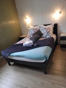 a unmade bed in a room with two lights on at Appart6 Pers garage centre à 500m in La Bresse